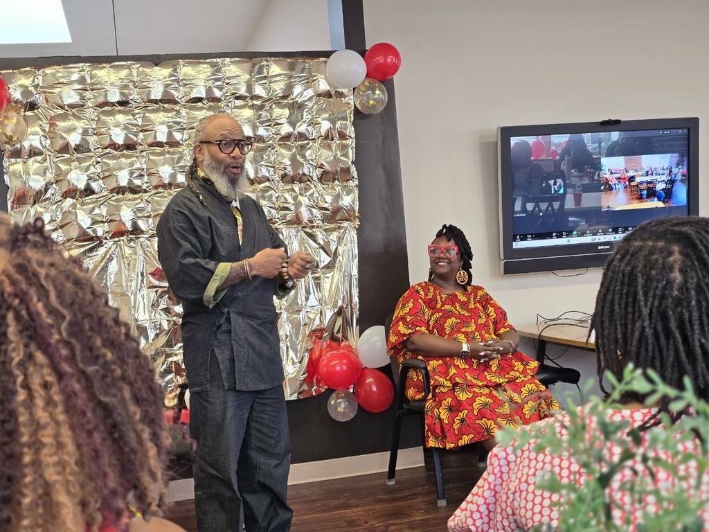 Heru TchaasAmen speaking at a celebration event