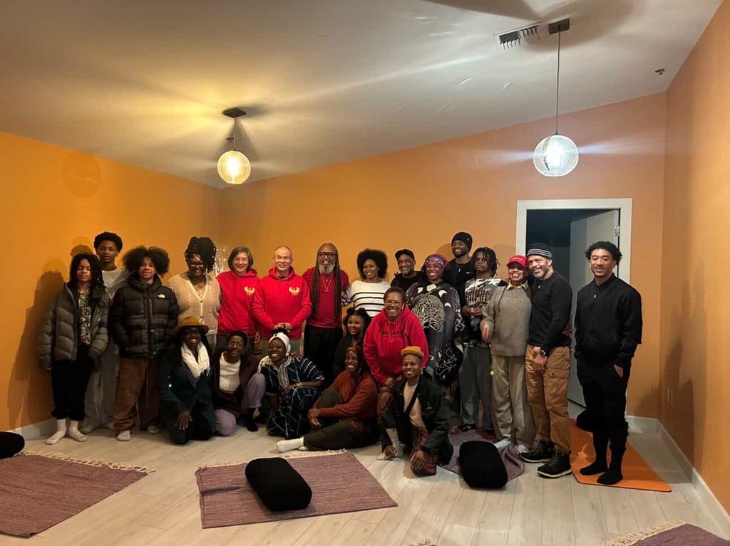 Community group photo in Heru Heals branded hoodies