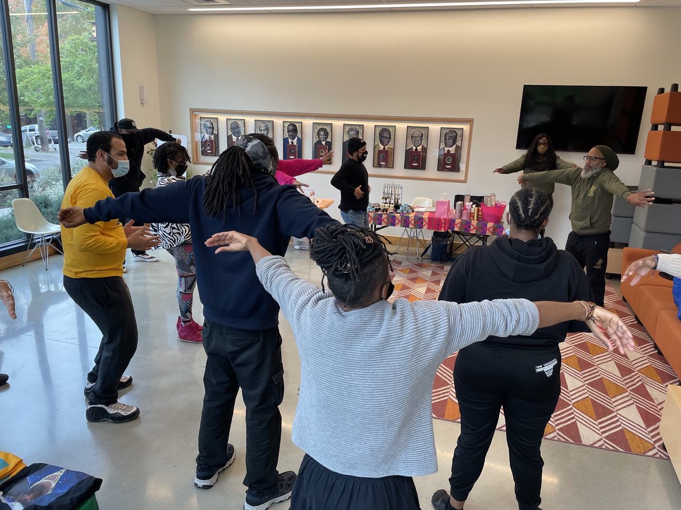 A group practicing Qigong together, arms raised