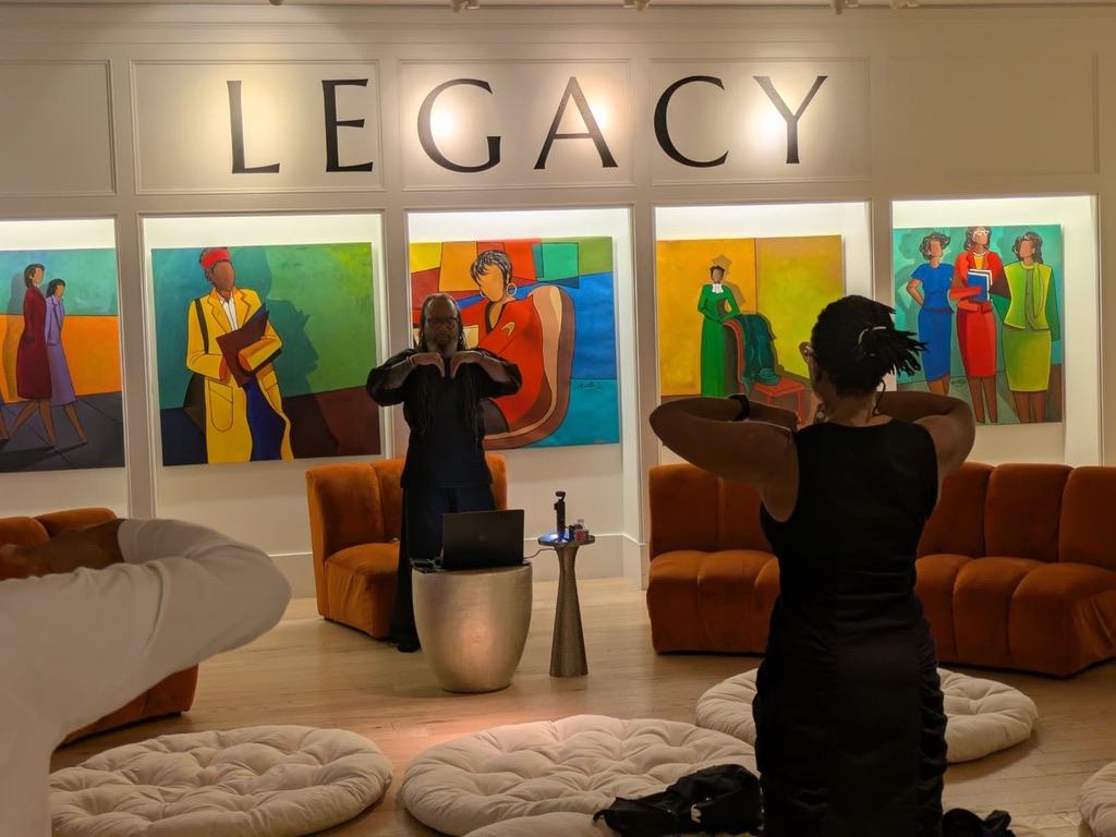 Heru TchaasAmen leading a session with a participant at the Legacy exhibit