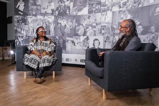 Heru TchaasAmen in conversation on a panel
